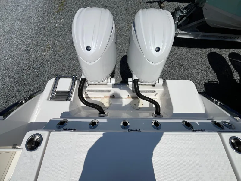 Slide: The Image of 2024 Robalo R250 Center Console with dual outboard engines, rear view. - 7