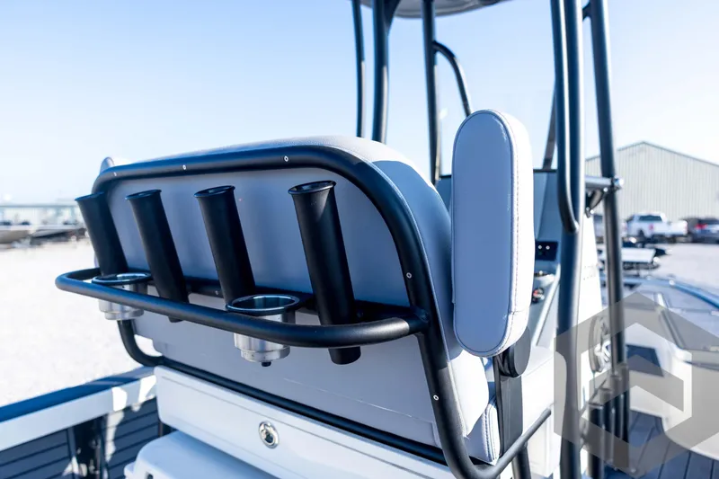 Slide: The Image of 2026 Pathfinder 2300 HPS boat interior with rod holders and seating, docked outdoors. - 101