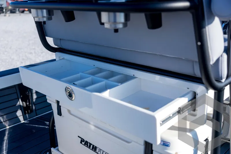 Slide: The Image of Open storage compartment on 2026 Pathfinder 2300 HPS boat, featuring organized sections. - 103