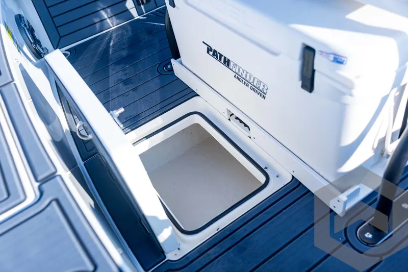 Slide: The Image of 2026 Pathfinder 2300 HPS boat storage compartment with open hatch on deck. - 106