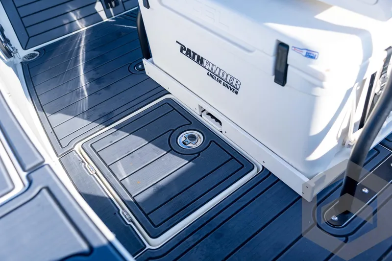 Slide: The Image of 2026 Pathfinder 2300 HPS boat deck with storage compartment and cooler. - 107