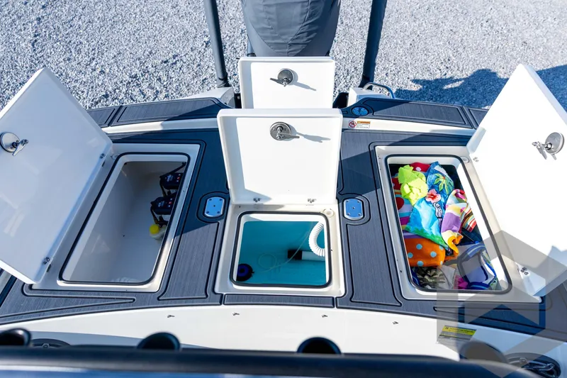 Slide: The Image of 2026 Pathfinder 2300 HPS boat storage compartments with open lids, showcasing interior space. - 111