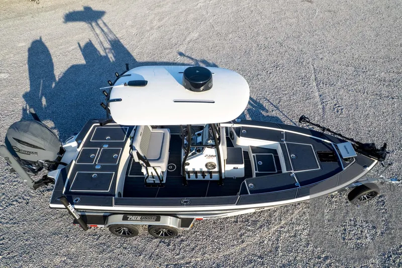 Slide: The Image of 2026 Pathfinder 2300 HPS boat on trailer, aerial view, parked on gravel. - 128