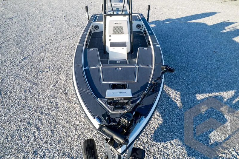 Slide: The Image of 2026 Pathfinder 2300 HPS boat on gravel, featuring Garmin equipment and sleek design. - 131