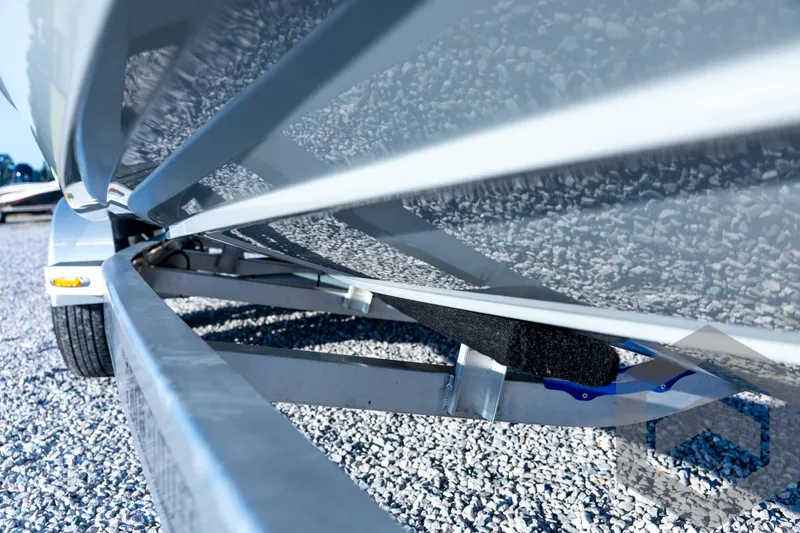 Slide: The Image of 2026 Pathfinder 2300 HPS boat on trailer, close-up view of hull and frame. - 14