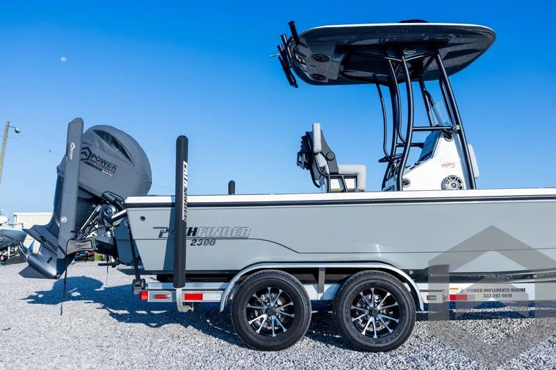 Slide: The Image of 2026 Pathfinder 2300 HPS boat on trailer, side view, clear blue sky background. - 15