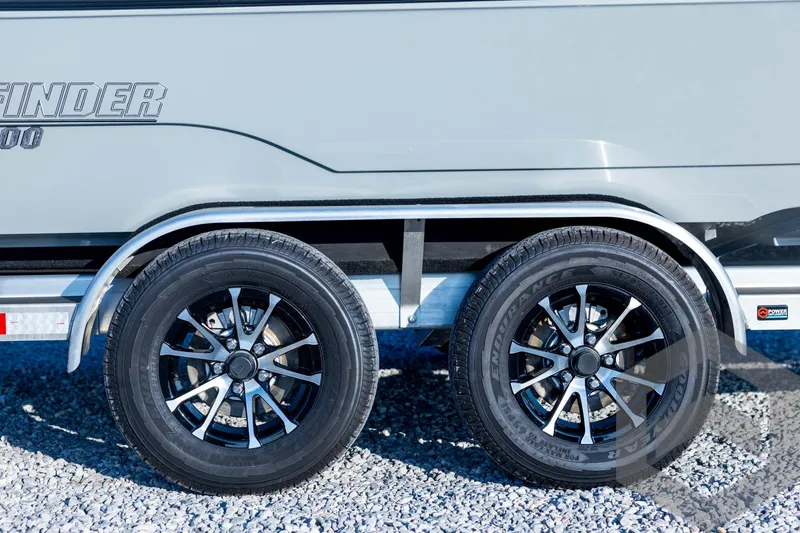 Slide: The Image of 2026 Pathfinder 2300 HPS trailer with dual black alloy wheels on gravel. - 16