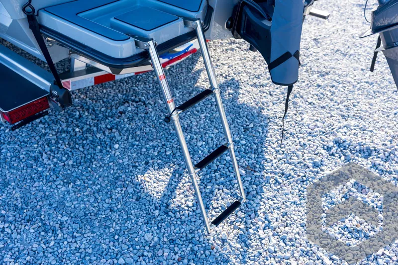 Slide: The Image of 2026 Pathfinder 2300 HPS boat ladder on gravel surface. - 28