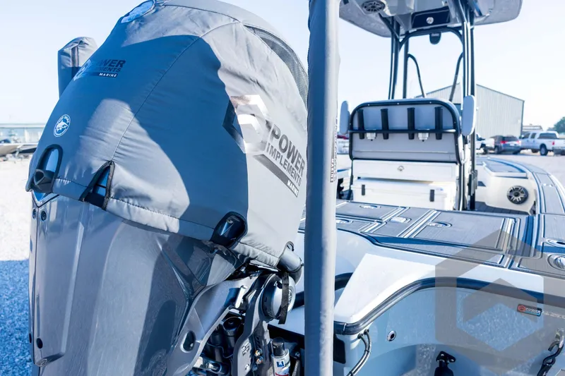 Slide: The Image of 2026 Pathfinder 2300 HPS boat with covered outboard motor, docked outdoors. - 30