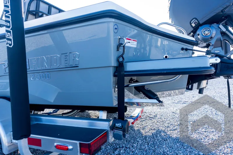 Slide: The Image of 2026 Pathfinder 2300 HPS boat rear view with trailer, showcasing sleek design. - 32