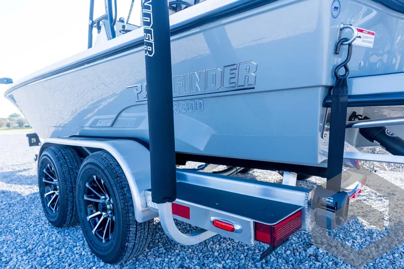 Slide: The Image of 2026 Pathfinder 2300 HPS boat on trailer, showcasing sleek design and dual axle wheels. - 33