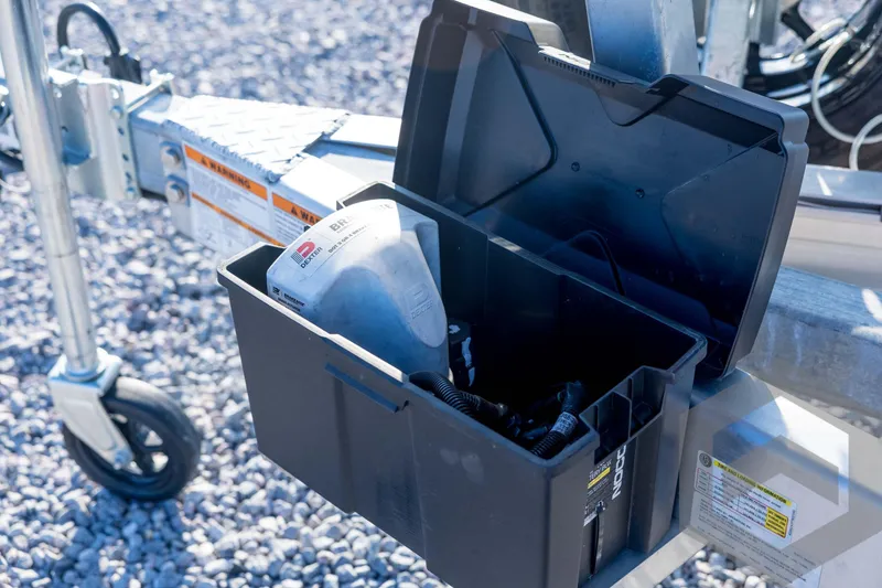 Slide: The Image of Open storage box on Pathfinder 2300 HPS trailer, containing a funnel and cables. - 39