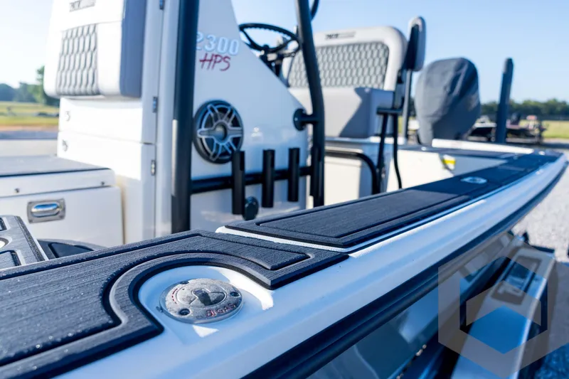 Slide: The Image of 2026 Pathfinder 2300 HPS boat, close-up of deck and seating area, outdoors. - 49