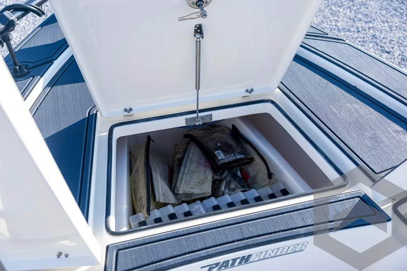Slide: The Image of Open storage compartment on 2026 Pathfinder 2300 HPS boat, showing organized gear inside. - 62