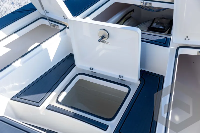 Slide: The Image of 2026 Pathfinder 2300 HPS boat storage compartments with open hatches and sleek design. - 64