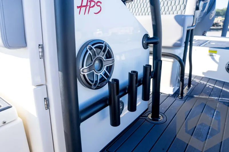 Slide: The Image of 2026 Pathfinder 2300 HPS boat interior with speaker and rod holders. - 69