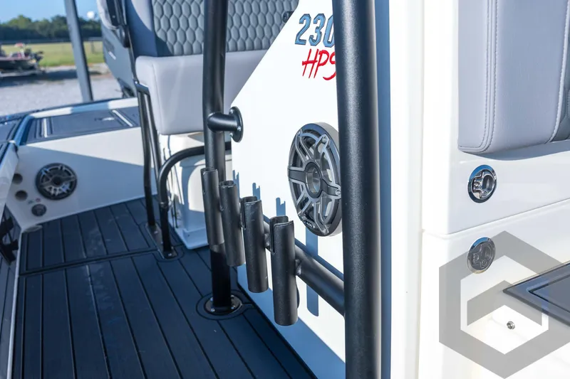 Slide: The Image of 2026 Pathfinder 2300 HPS boat interior with rod holders and speaker detail. - 70