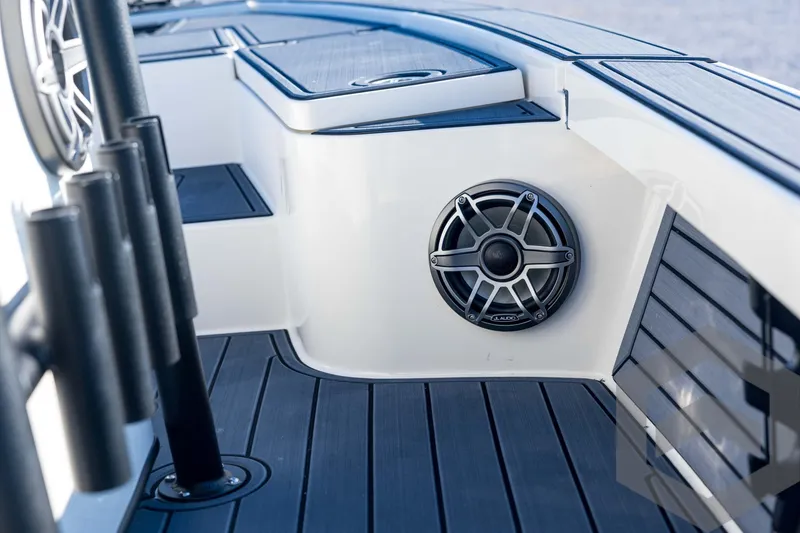 Slide: The Image of 2026 Pathfinder 2300 HPS boat interior with speaker and rod holders. - 74
