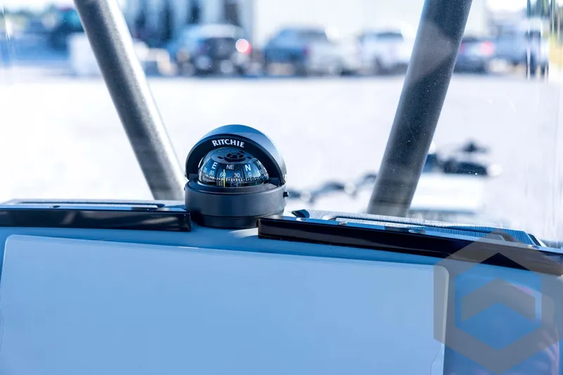 Slide: The Image of Compass on 2026 Pathfinder 2300 HPS boat dashboard, with blurred background. - 83