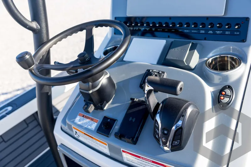 Slide: The Image of 2026 Pathfinder 2300 HPS boat console with steering wheel and controls. - 85