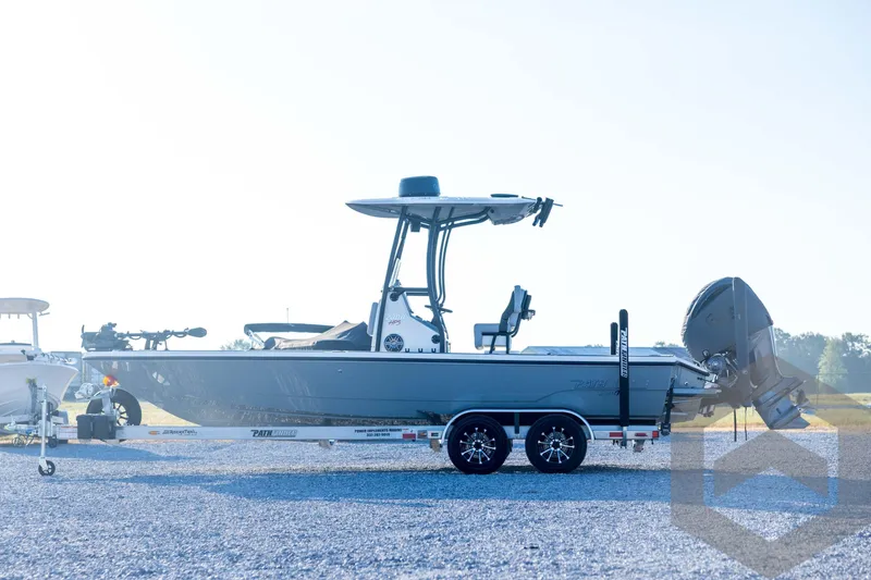 Slide: The Image of 2026 Pathfinder 2300 HPS boat on trailer, side view, outdoors. - 9