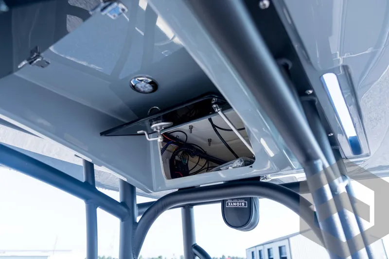 Slide: The Image of 2026 Pathfinder 2300 HPS boat interior, showcasing electronic wiring and storage compartment. - 96
