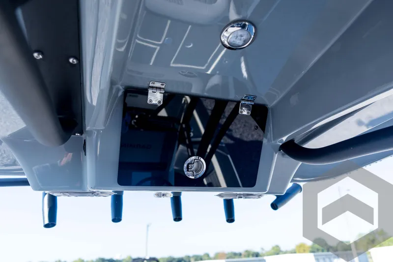 Slide: The Image of 2026 Pathfinder 2300 HPS boat console with rod holders and storage compartment. - 97