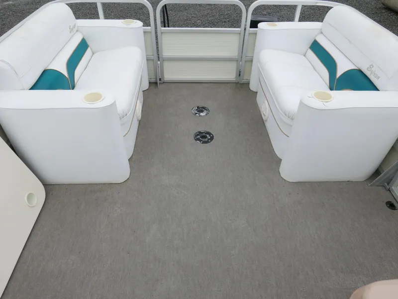 Slide: The Image of 1996 Sylvan 820 Cruise Special Edition boat interior with white seating and teal accents. - 5