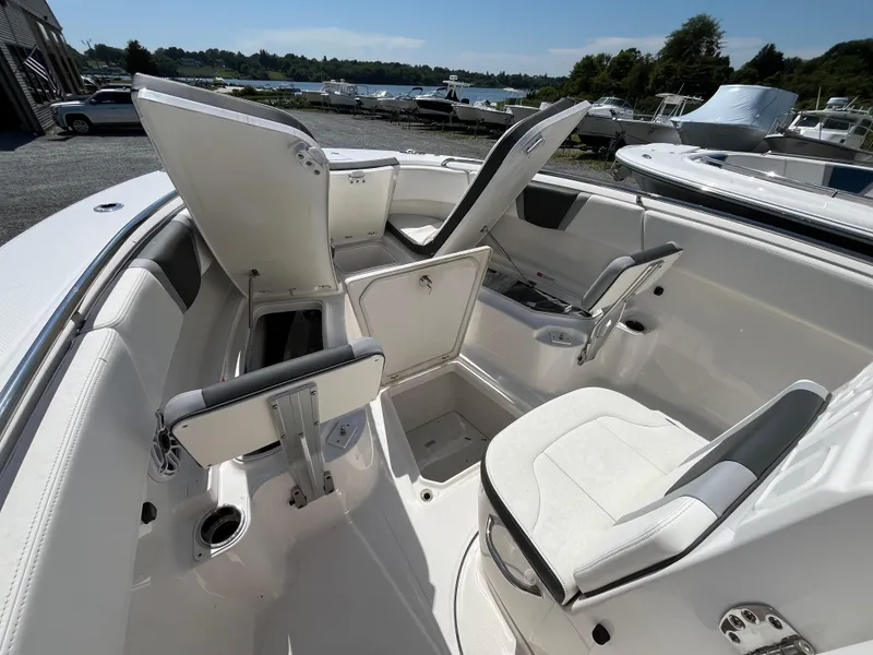Slide: The Image of 2024 Robalo R270 Center Console anchor compartment with open hatch and chain. - 13