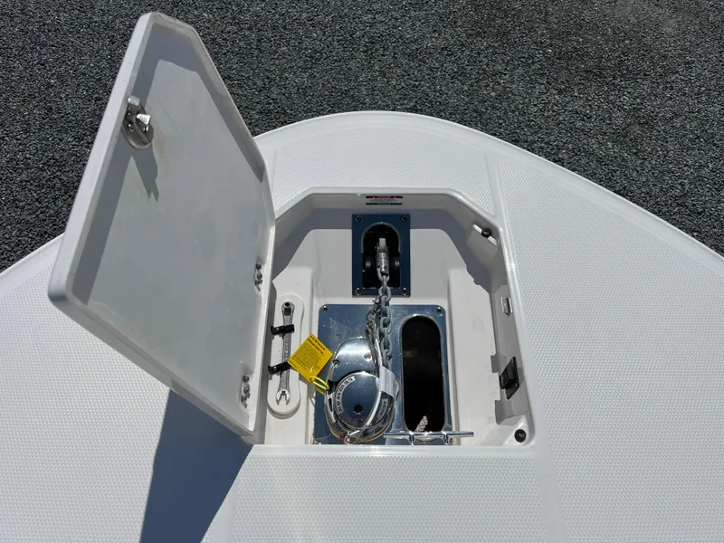 Slide: The Image of 2024 Robalo R270 Center Console boat with spacious deck and seating, displayed outdoors. - 14