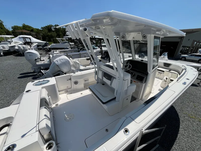 Slide: The Image of 2024 Robalo R270 Center Console dashboard with dual Simrad displays and steering wheel. - 2