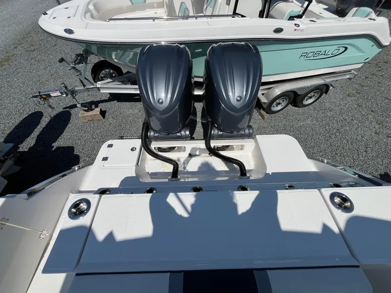 Slide: The Image of 2024 Robalo R270 Center Console storage with Simrad marine radio and microphone. - 3
