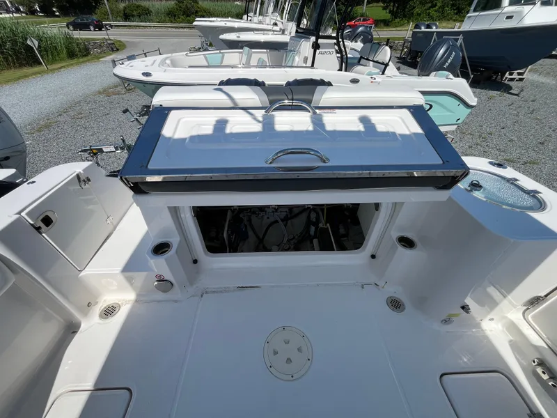 Slide: The Image of 2024 Robalo R270 Center Console boat with dual outboard engines, parked on a trailer. - 5