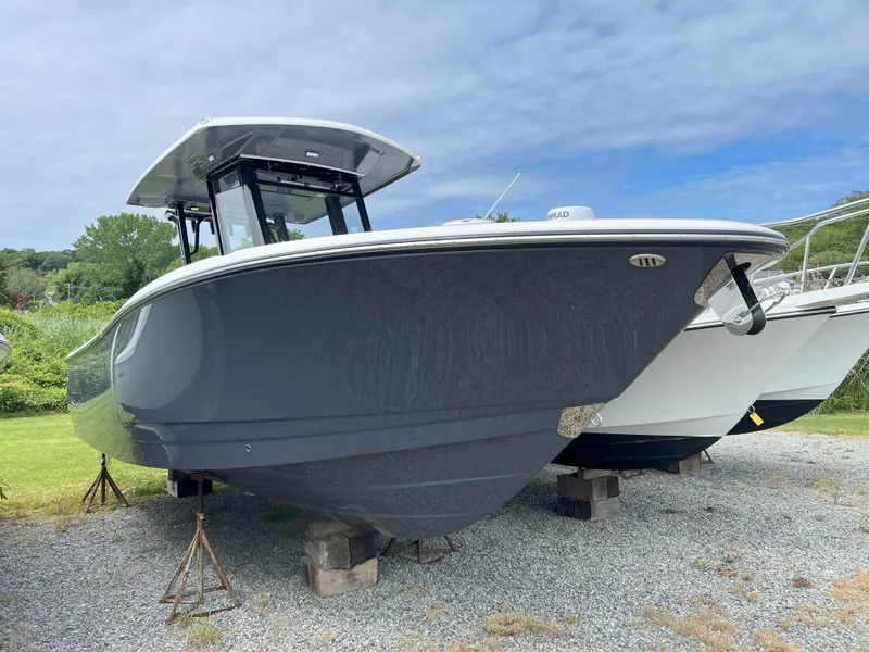 Slide: The Image of 2025 Robalo R270 Center Console boat with spacious deck and modern design. - 1