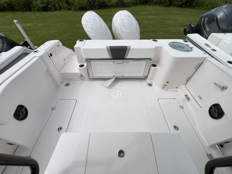 Slide: The Image of 2025 Robalo R270 Center Console boat interior with open compartments and Yamaha engines. - 3