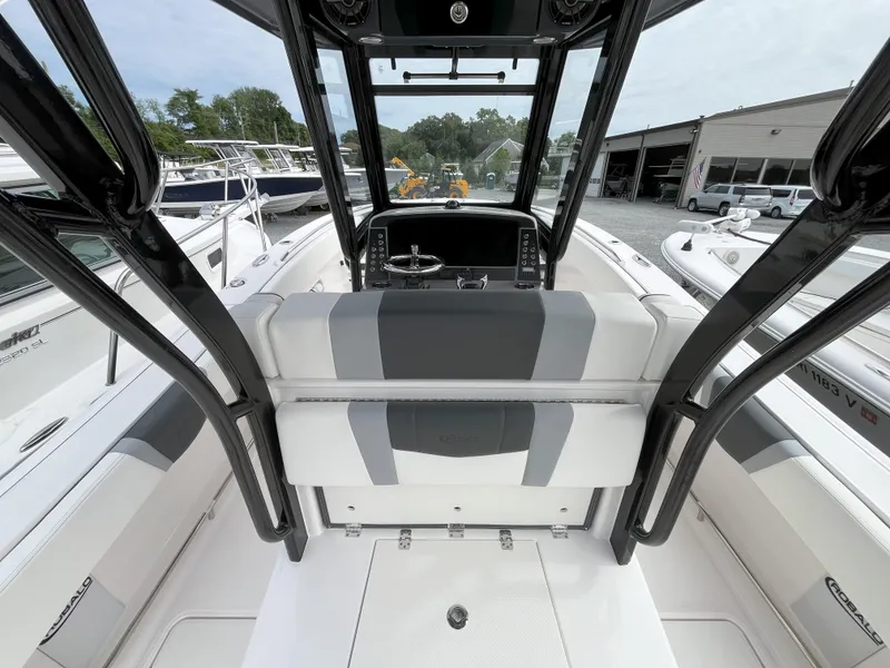 Slide: The Image of 2025 Robalo R270 Center Console boat dashboard with steering wheel and controls. - 5