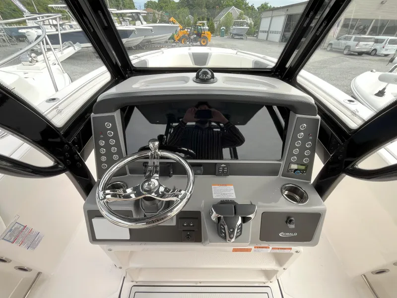 Slide: The Image of 2025 Robalo R270 Center Console boat interior with white seating and modern design. - 6