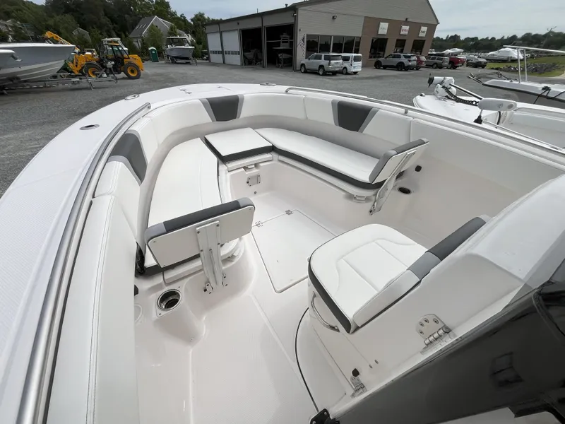 Slide: The Image of 2025 Robalo R270 Center Console boat with open storage compartments and seating. - 7