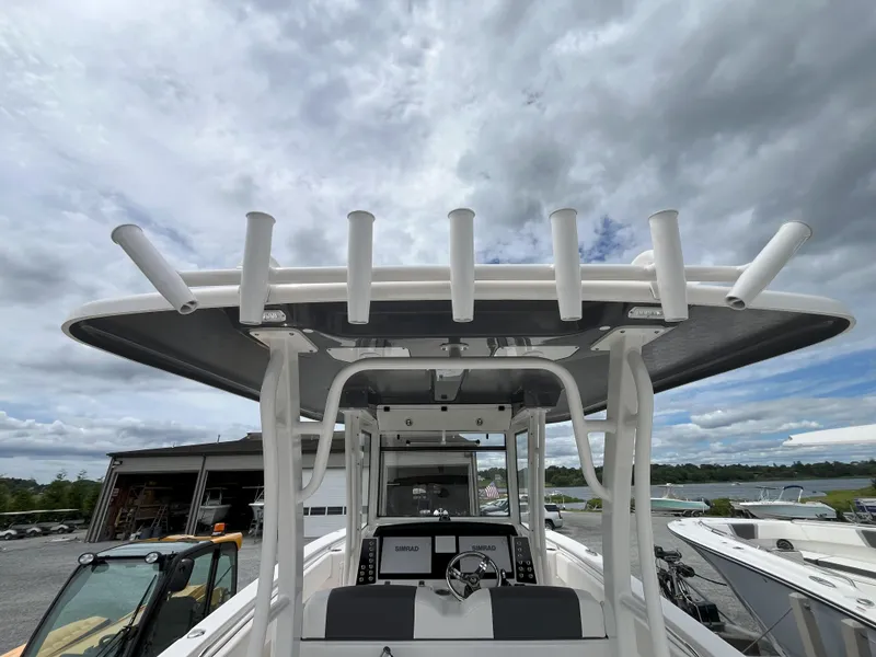 Slide: The Image of 2024 Robalo R302 Center Console helm with dual Simrad displays and steering wheel. - 4