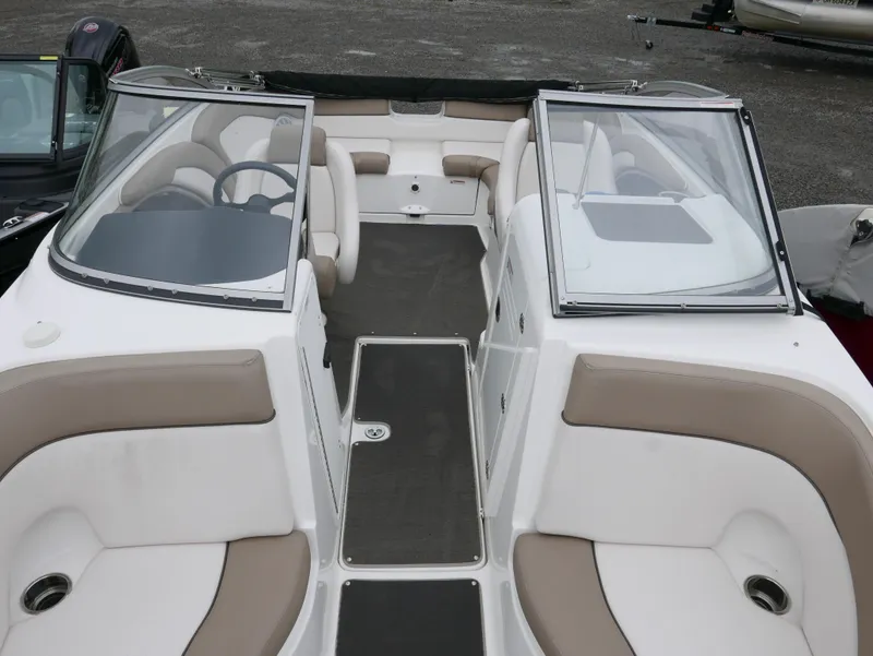 Slide: The Image of Interior view of a 2011 Yamaha SX240 boat with beige seating. - 11