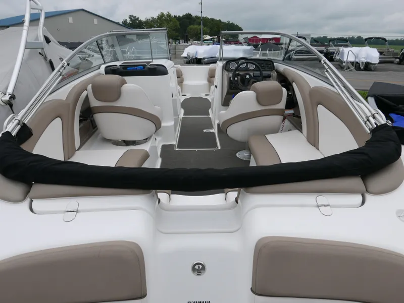Slide: The Image of Interior of a 2011 Yamaha SX240 boat with beige seating. - 12