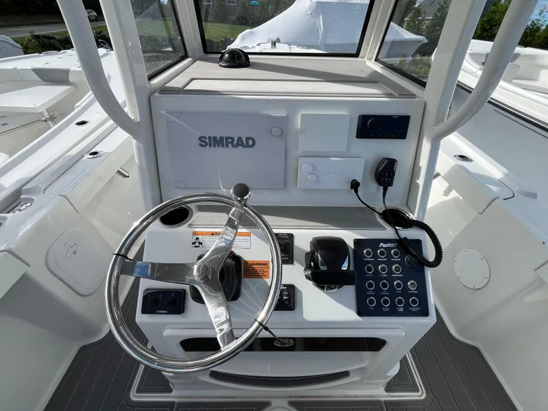 Slide: The Image of 2024 Parker 2400 Center Console boat interior with seating and motor, showcasing modern design. - 3