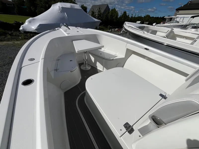 Slide: The Image of 2024 Parker 2400 Center Console boat interior with seating and table setup. - 7