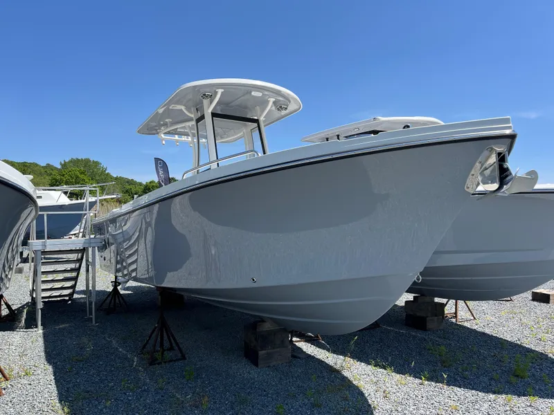The Image of 2024 Parker 2600 Center Console boat displayed outdoors on a sunny day. - 1