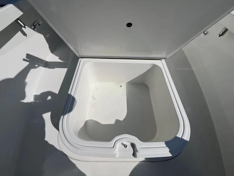 Slide: The Image of Open storage compartment on 2024 Parker 2600 Center Console boat. - 10