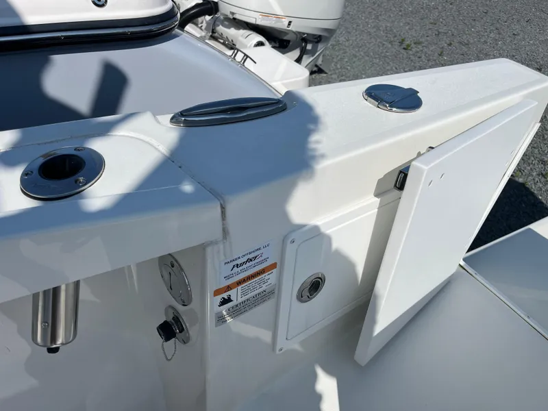 Slide: The Image of 2024 Parker 2600 Center Console boat deck with storage compartment and fittings. - 14