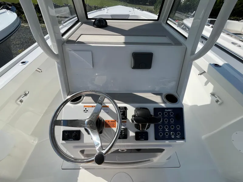 Slide: The Image of 2024 Parker 2600 Center Console boat dashboard with steering wheel and control panel. - 5