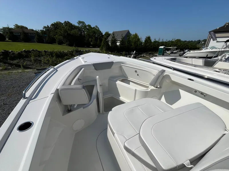 Slide: The Image of 2024 Parker 2600 Center Console boat interior with white seating and storage compartments. - 7