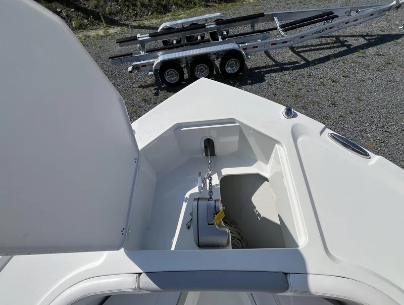 Slide: The Image of 2024 Parker 2600 Center Console boat anchor compartment with trailer in background. - 8
