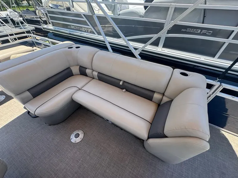 Slide: The Image of 2024 Sun Tracker Fishin' Barge 22 DLX, featuring comfortable seating and cup holders. - 4